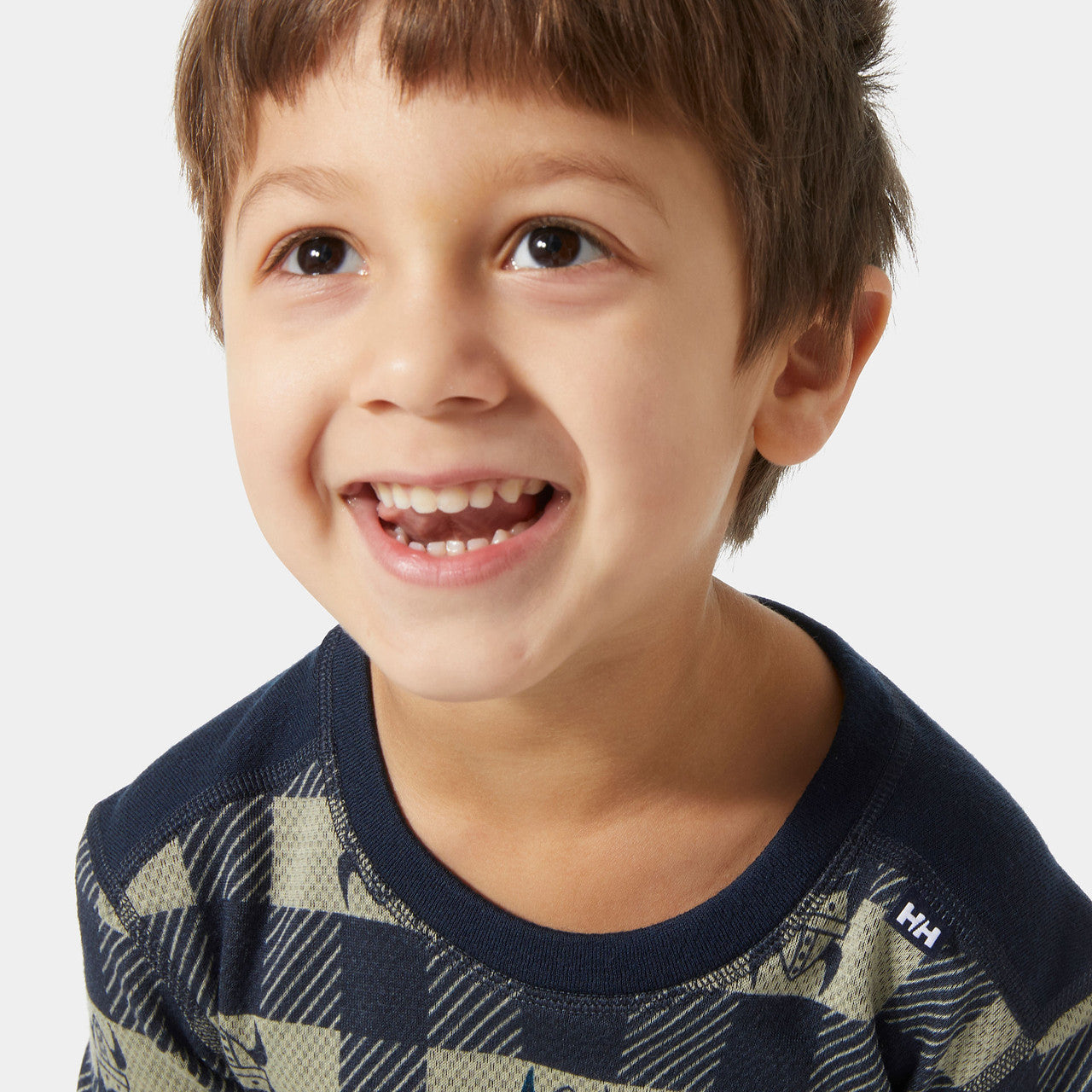 Smiling child sitting at a table in a cozy indoor setting after outdoor play