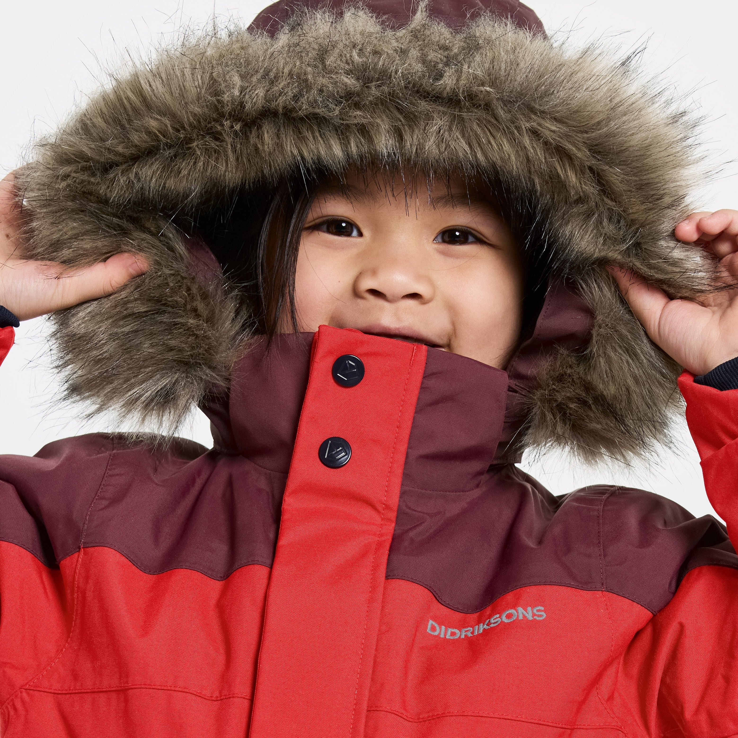 Child enjoying outdoor ice skating in durable, warm winter overalls