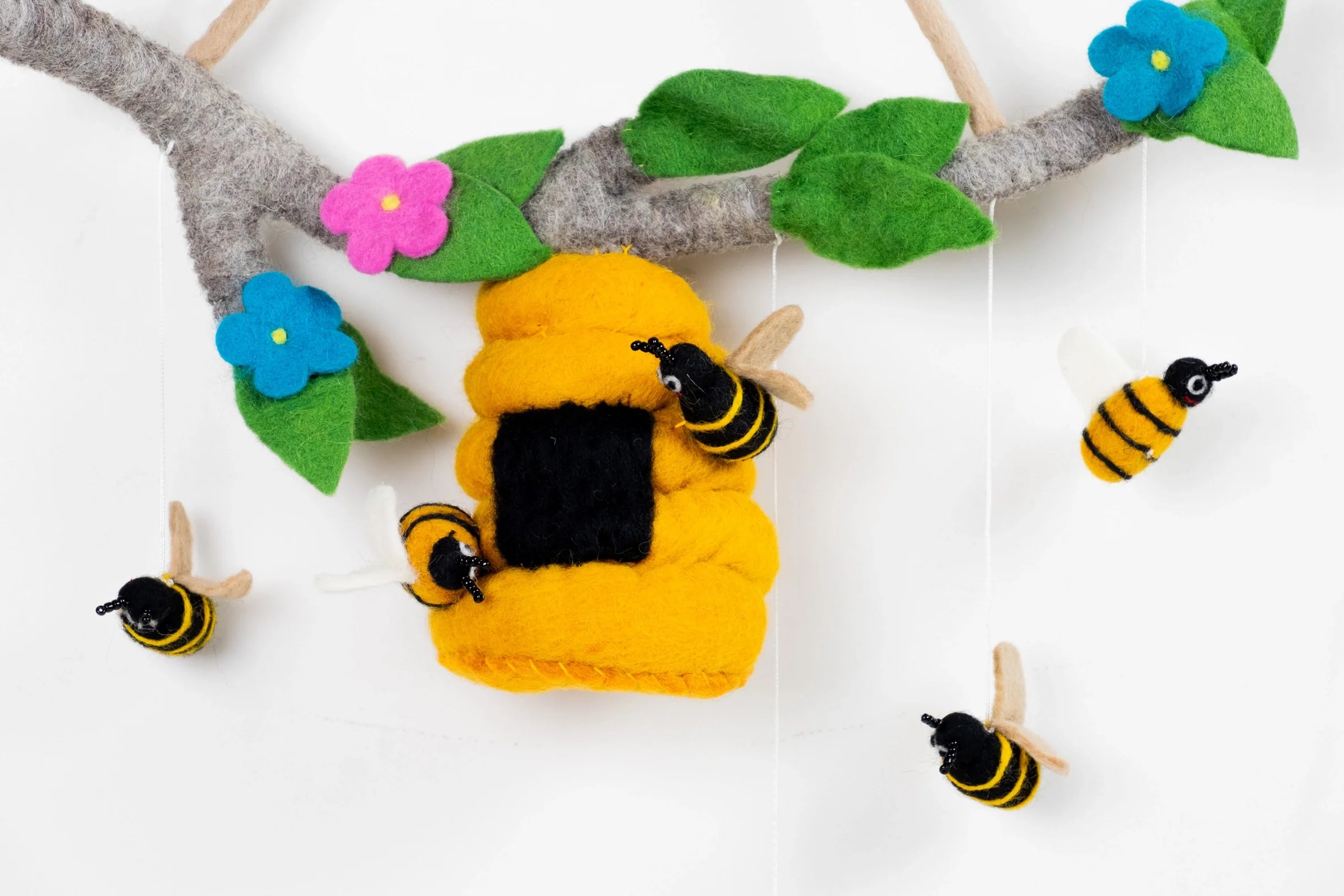 Handcrafted felt bee mobile with honeycomb and colorful flowers for nature-inspired nursery decor